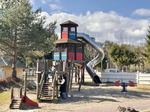 a playground with a slide in a park at Tiny Home Strandkoje 823 in Göhren