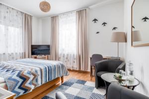 a hotel room with a bed and a table and chairs at Villa Walir - Spa Hotel Garni SUPERIOR in Mariánské Lázně
