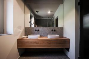 a bathroom with two sinks and a mirror at Villa La Biancolilla in Garda +26 photos