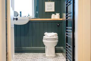 a bathroom with a white toilet and a sink at The Fairlie Suite No1 in Prestwick +19 photos
