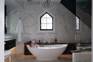 a bathroom with a bath tub and a window at Inn at Taughannock Falls in Ithaca +99 photos