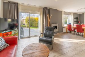 a living room with a couch and a table at Californiëweg 9A in De Koog