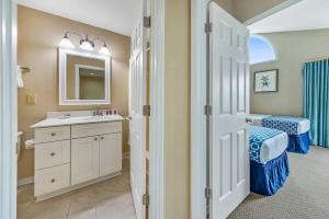a bathroom with a sink and a mirror at 2 Bedroom Condo on Lake with Jacuzzi in New Bern