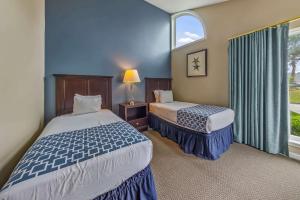 a hotel room with two beds and a window at 2 Bedroom Condo on Lake with Jacuzzi in New Bern