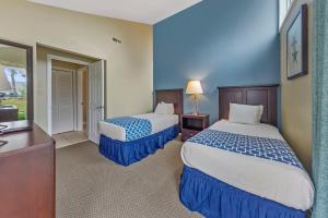 a hotel room with two beds and a desk at 2 Bedroom Condo on Lake with Jacuzzi in New Bern +30 photos