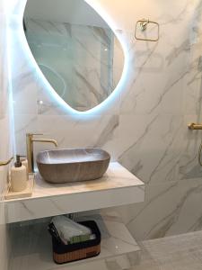 a bathroom with a sink and a mirror at Th Tsimas Luxury studio 4 in Skala Potamias +16 photos