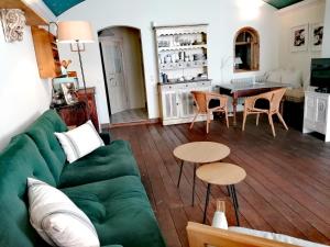 a living room with a green couch and a table at Peter 7 Altstadt - Dachstudio & Peter 7 Altstadt - Erdgeschoss mit Gartenblick in Görlitz