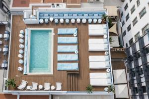 an external view of a building with a swimming pool at Neptuno Hotel & SPA 4 Sup in Calella +49 photos