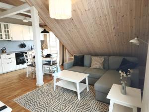 a living room with a couch and a table at Loft Apartment Self Check-in in Mažeikiai +2 photos