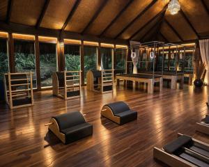 a room with chairs and tables on a wooden floor at Canto Leela - Bangalôs pé na areia in Serra Grande