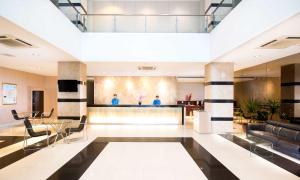 a lobby of a hotel with a bar and chairs at Hotel 88 - Mangga Besar VIII Jakarta By WH in Jakarta