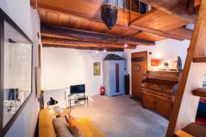 a living room with a couch and a piano at Centovalli Rustic near Locarno in Intragna