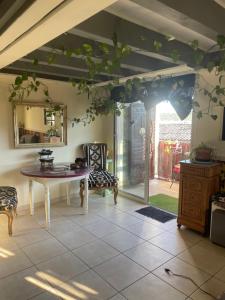 a living room with a table and a chair at La Belle Vue in Ganges