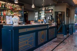 a bar with a blue and yellow counter at The California - Kings Cross St Pancras, London in London