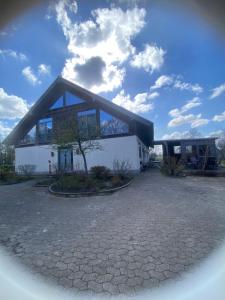a large white house with a black roof at Meyer im Moor in Grasberg