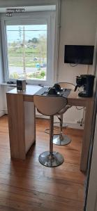 an office with a desk with a computer and a window at chambres randonneurs in Plestin-les-Grèves