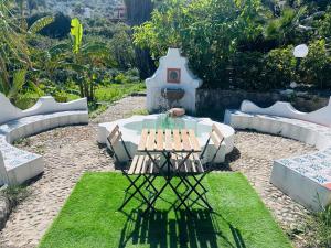 a picnic table and bench in a garden at Villa Tiche in Cefalù +78 photos