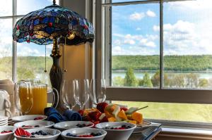a table with bowls of food and a window at Inn at Taughannock Falls in Ithaca