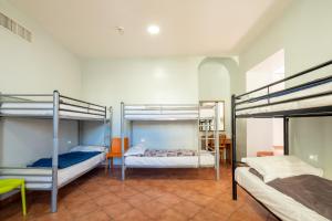 a room with three bunk beds in a room at Alessandro Palace & Bar in Rome +120 photos