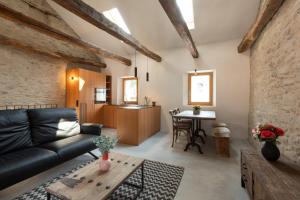 a living room with a couch and a table at Charming Rustico Losone near Locarno in Losone