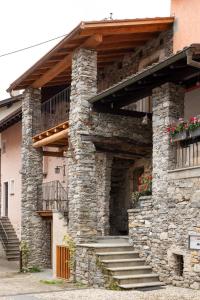 a stone building with stairs and a balcony at Charming Rustico Losone near Locarno in Losone