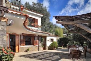 a patio of a house with a table and chairs at GOCCE VILLAS - Il Frantoio in Massa Lubrense
