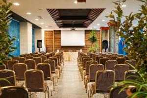 a room with rows of chairs and a projection screen at Villaggio Giardini D'Oriente in Nova Siri Marina +66 photos