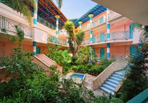 an apartment building with stairs and a courtyard at Villaggio Giardini D'Oriente in Nova Siri Marina