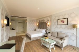 a hotel room with a bed and a couch at Clarks Inn Bokaro in Bokāro +24 photos