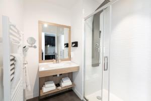 a white bathroom with a sink and a shower at Le Barracuda & Spa, pieds dans l'eau, vue mer, espace bien-être offert in Brest +62 photos