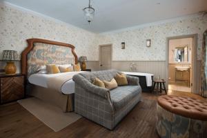 a bedroom with a bed and a couch at Beadnell Towers Hotel in Beadnell