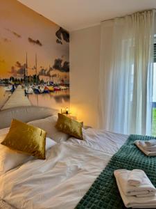 a white bed with gold pillows on it in a bedroom at See you! in Pouch