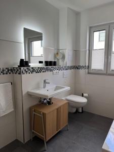 a bathroom with a sink and a toilet at See you! in Pouch +28 photos