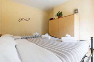 a bedroom with a large bed with towels on it at Sleep & Fly - Immobili e Soluzioni Rent in Orio al Serio