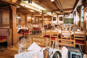 a restaurant with tables and chairs in a room at Gasthof Diem in Krumbach