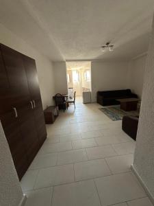 an empty living room with a couch and a table at Salihu in Ferizaj