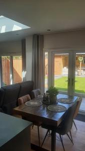 a dining room with a table and a couch at Coastal Rest in Beadnell