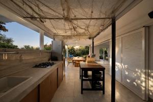 an open kitchen with a counter and a table at Villa GIUSEPPE in Potocnica
