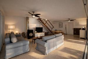 a living room with two couches and a staircase at Villa GIUSEPPE in Potocnica