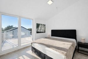 a bedroom with a bed and a large window at Villa GIUSEPPE in Potocnica +40 photos