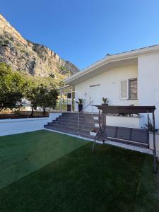 a house with a green yard with stairs and grass at Villa Amelia in Capaci