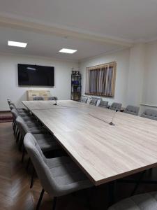 a large conference room with a large table and chairs at Гостиница Asan Ali in Kapchagay