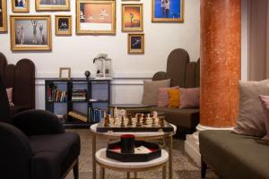 a living room with a chess set on a table at Grand Hôtel du Midi Montpellier - Opéra Comédie in Montpellier +62 photos