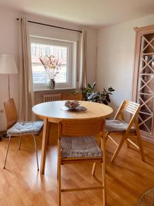 a table and chairs in a room with a window at Voll ausgestattete, helle Ferienwohnung auf 80 qm in Wutöschingen