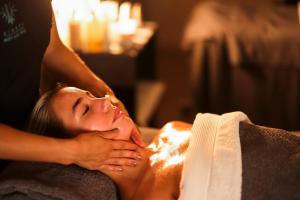 a woman getting a massage in a towel at The Kinmel & Kinspa in Abergele