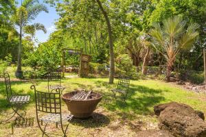 a group of chairs and a table and a sign at Canopy Lodge - Perfect Mauritius Trip in Tamarin