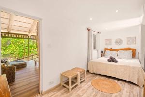 a bedroom with a bed and a large window at Canopy Lodge - Perfect Mauritius Trip in Tamarin +37 photos