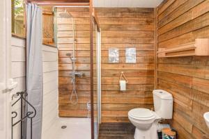 a bathroom with a toilet and a shower at Canopy Lodge - Perfect Mauritius Trip in Tamarin