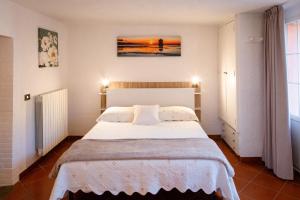 a bedroom with a white bed in a room at Casale Gli Ulivi in Orbetello +119 photos