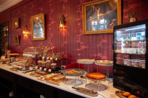 a bakery with a buffet of food on a counter at Grand Hôtel du Midi Montpellier - Opéra Comédie in Montpellier